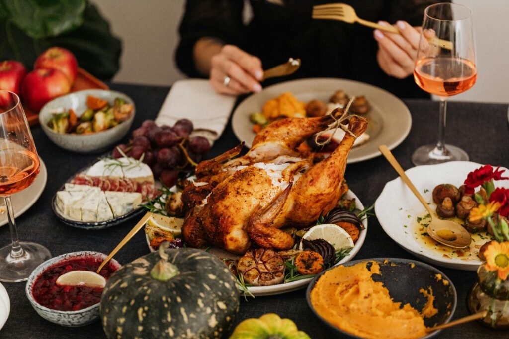 A festive Thanksgiving dinner spread featuring a golden roasted turkey, vegetables, and wine, perfect for holiday dining.